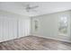 Bedroom featuring wood-look floors, light green walls, ceiling fan, closet, and windows at 517 Seville Ave, Altamonte Springs, FL 32714