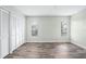 Bedroom featuring wood-look floors, light green walls, closet, and windows at 517 Seville Ave, Altamonte Springs, FL 32714