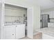 Laundry room features a washer, dryer, and hot water tank at 517 Seville Ave, Altamonte Springs, FL 32714