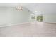 Bright and airy living room featuring tile floors, vaulted ceilings, and modern lighting at 517 Seville Ave, Altamonte Springs, FL 32714