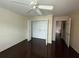 Bedroom with a large closet, wood-look floors, and a ceiling fan at 5459 Vineland Rd # 4310, Orlando, FL 32811