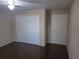 Bedroom features wood floors, a ceiling fan, and a double closet for ample storage at 5459 Vineland Rd # 4310, Orlando, FL 32811