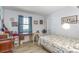 Bedroom with a bright window, vintage sewing accessories, and light-colored wood-look flooring at 59 Aberdeen Cir, Leesburg, FL 34788