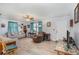 Comfortable living room features neutral walls, updated flooring, a ceiling fan and abundant natural light at 59 Aberdeen Cir, Leesburg, FL 34788