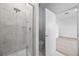 Modern bathroom featuring marble-look shower and an open doorway to bedroom at 625 Trikomo Dr, Davenport, FL 33896