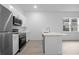 Kitchen with stainless steel appliances and a center island with quartz countertops at 625 Trikomo Dr, Davenport, FL 33896