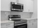 Modern kitchen featuring stainless steel appliances, white cabinetry and subway tile backsplash at 625 Trikomo Dr, Davenport, FL 33896