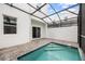 Tranquil backyard pool with a screened enclosure and a private patio area at 625 Trikomo Dr, Davenport, FL 33896