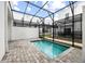 Inviting backyard pool area enclosed with a screen, offering privacy and relaxation at 625 Trikomo Dr, Davenport, FL 33896