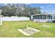 Enjoy outdoor activities in this community backyard, featuring lush lawn, seating, and horseshoe pits at 7 Great Oak Dr, Fruitland Park, FL 34731