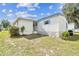 A lovely mobile home's rear exterior shows the white siding and cozy backyard area, offering private outdoor space at 7 Great Oak Dr, Fruitland Park, FL 34731