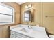 The bathroom features a white vanity with marble countertop and a framed mirror at 7 Great Oak Dr, Fruitland Park, FL 34731