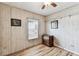 Bedroom with wood-look floors, small window, ceiling fan, and decorative cabinet at 7 Great Oak Dr, Fruitland Park, FL 34731