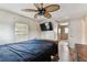 Large bed in this bedroom, a ceiling fan and mounted TV at 7 Great Oak Dr, Fruitland Park, FL 34731