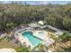 Aerial view of community pool and spa, surrounded by palm trees and lounge chairs, perfect for relaxation at 7 Great Oak Dr, Fruitland Park, FL 34731