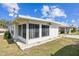 Exterior shot of well-maintained white siding mobile home, showing tidy landscaping and a welcoming facade at 7 Great Oak Dr, Fruitland Park, FL 34731