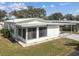 Bright single story home with a carport and a well-manicured lawn on a sunny day at 7 Great Oak Dr, Fruitland Park, FL 34731