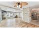 Open-concept living area featuring wood floors, natural light, and seamless transition to the kitchen at 7 Great Oak Dr, Fruitland Park, FL 34731