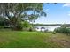 The backyard boasts a view of the lake with a dock and lovely trees at 703 E Lakeshore Dr, Ocoee, FL 34761