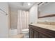 Bathroom with vanity and sink and a shower-tub with a white curtain at 703 E Lakeshore Dr, Ocoee, FL 34761