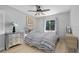 Cozy bedroom with natural light, ceiling fan, and a calm color scheme to inspire relaxation at 703 E Lakeshore Dr, Ocoee, FL 34761