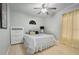 Bright bedroom with neutral walls, light wood floors, and a modern ceiling fan for a peaceful retreat at 703 E Lakeshore Dr, Ocoee, FL 34761