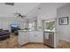 Kitchen island with granite countertops, stainless steel dishwasher, and white cabinets at 703 E Lakeshore Dr, Ocoee, FL 34761