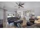 Open-concept living room featuring tiled flooring and a view of the dining room and kitchen at 703 E Lakeshore Dr, Ocoee, FL 34761