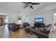 Comfortable living room with leather seating and a large television at 703 E Lakeshore Dr, Ocoee, FL 34761