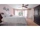 Spacious main bedroom with ceiling fan, neutral carpet, and natural light at 703 E Lakeshore Dr, Ocoee, FL 34761