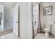 Clean bathroom featuring a shower with a gray curtain, toilet, and neutral tile flooring at 7104 Painted Bunting Way, St Cloud, FL 34773