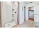 Walk-in shower with neutral colored shower curtain and view of the walk-in closet with shelving at 7104 Painted Bunting Way, St Cloud, FL 34773