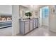 Bathroom featuring double vanity with granite counters and large mirror, offering a modern and stylish design at 7104 Painted Bunting Way, St Cloud, FL 34773