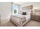 Comfortable bedroom with a decorative headboard and textured accent wall at 7104 Painted Bunting Way, St Cloud, FL 34773