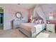 Pretty bedroom with a canopy bed, butterfly decor, and soft pink walls at 7104 Painted Bunting Way, St Cloud, FL 34773