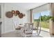 Bright dining area with decorative wall art and sliding glass doors offering a scenic outdoor view at 7104 Painted Bunting Way, St Cloud, FL 34773