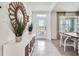 Bright foyer with a decorative mirror, white console, and views to the outside at 7104 Painted Bunting Way, St Cloud, FL 34773