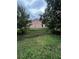 View of the home's backyard showcasing mature landscaping and ample green space at 7132 Laurel Hill Dr, Orlando, FL 32818