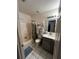 Functional bathroom with a shower-tub combination, vanity sink, and convenient storage shelves for personal care items at 7132 Laurel Hill Dr, Orlando, FL 32818