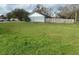 Large backyard with a wooden fence and grassy area at 7277 Pebble Pass Loop Loop, Lakeland, FL 33810