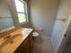 Bathroom featuring tile floors, a vanity, toilet, and window at 7277 Pebble Pass Loop Loop, Lakeland, FL 33810