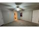 A carpeted bedroom features a ceiling fan and window with natural light at 7277 Pebble Pass Loop Loop, Lakeland, FL 33810