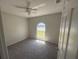 Cozy bedroom with carpeted floors, a ceiling fan, and a large window at 7277 Pebble Pass Loop Loop, Lakeland, FL 33810