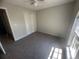 Bright bedroom featuring neutral walls, carpeted floors, and a window and a ceiling fan at 7277 Pebble Pass Loop Loop, Lakeland, FL 33810