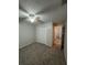 Bedroom featuring carpet floors, a ceiling fan, and a closet with folding doors at 7277 Pebble Pass Loop Loop, Lakeland, FL 33810