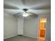 Carpeted bedroom with neutral color walls with ceiling fan and access to a bathroom at 7277 Pebble Pass Loop Loop, Lakeland, FL 33810