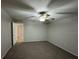 Spacious bedroom with a ceiling fan and neutral carpet at 7277 Pebble Pass Loop Loop, Lakeland, FL 33810