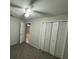 Bedroom featuring carpet flooring, ceiling fan and closet at 7277 Pebble Pass Loop Loop, Lakeland, FL 33810