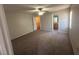 Bedroom with carpet flooring, ceiling fan, and connecting bathroom and walk-in closet at 7277 Pebble Pass Loop Loop, Lakeland, FL 33810