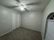 Neutral bedroom with standard closet, window, and ceiling fan at 7277 Pebble Pass Loop Loop, Lakeland, FL 33810